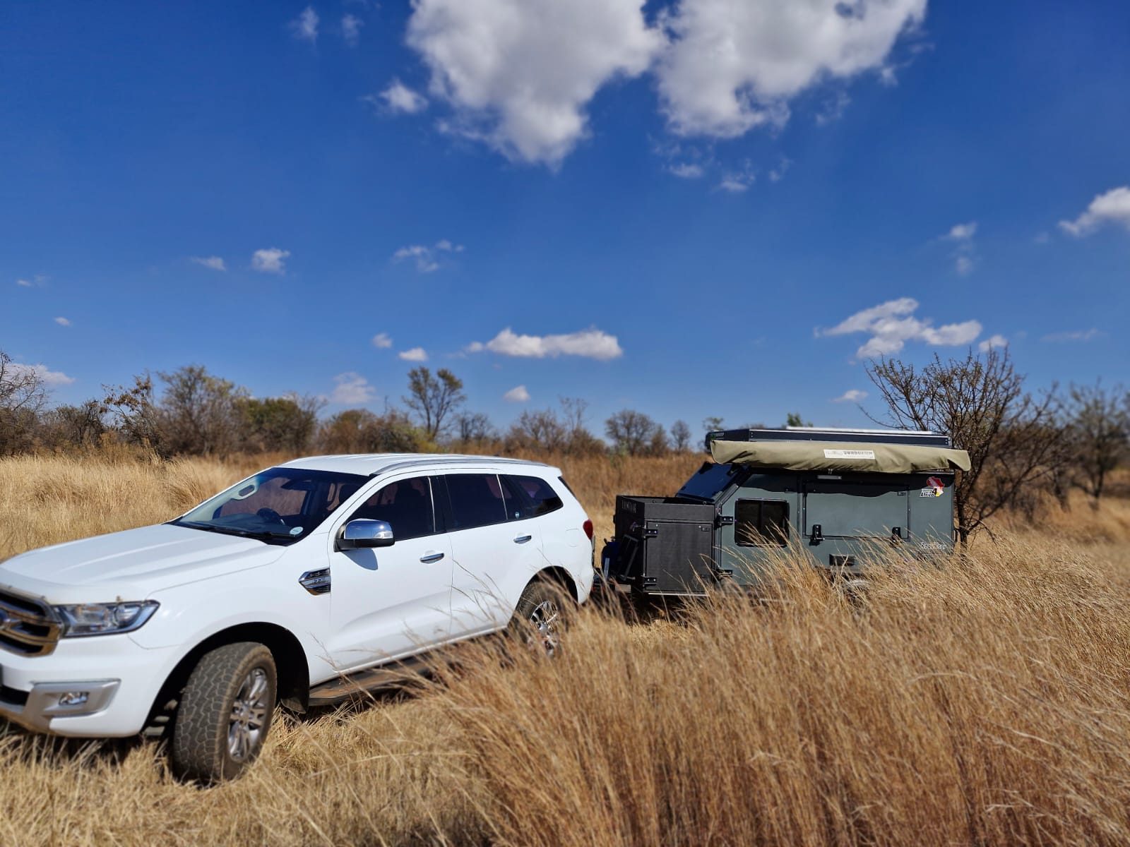 Off-road caravan hitched to a 4x4 in the bushveld, listed on Kampi