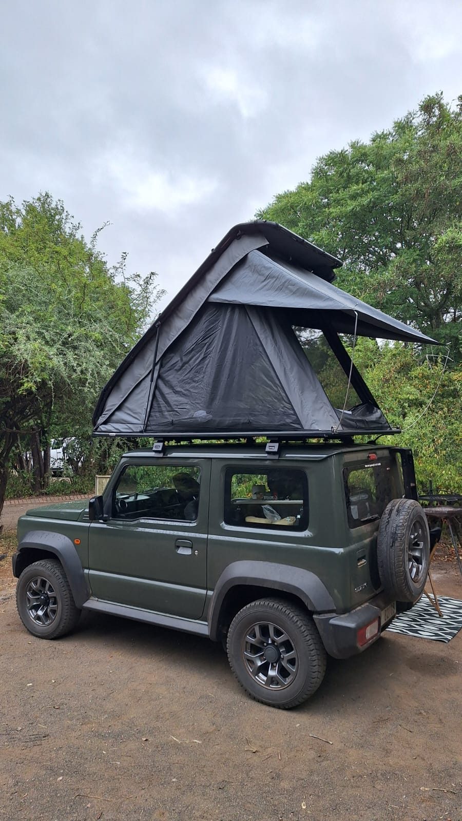 Cosy made-up bed inside a South African off-road camper trailer with soft interior lighting