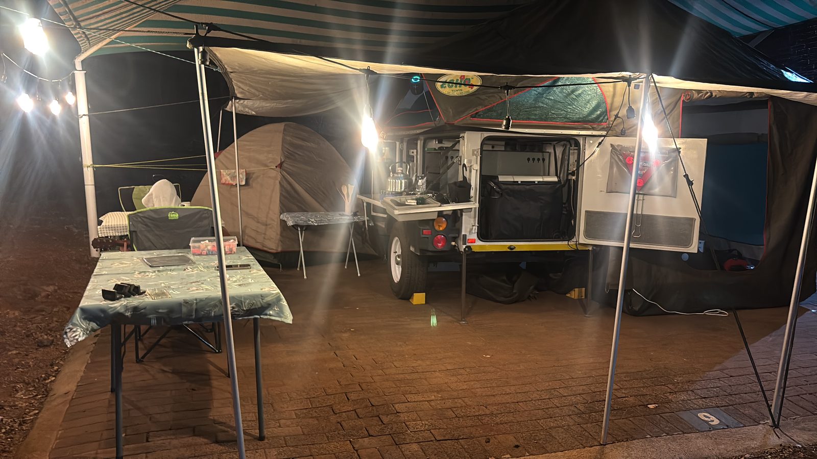 Camping trailer fully set up at a South African campsite during festival season