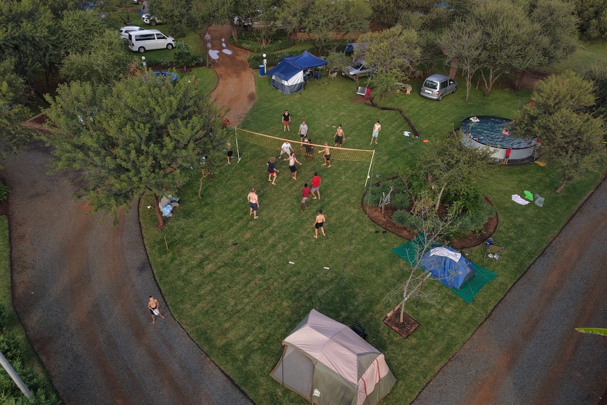 Aerial view of Plaas Toe camping area showing the pool, playground, and camping stands in the Dinokeng bushveld